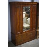 Late Victorian mahogany wardrobe, the glazed door over two short and one long drawer with plinth