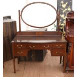 1920s mahogany dressing table, the oval mirror over a bowfront drawer and kneehole flanked by two