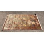 Persian design rug with multiple panels on a light coloured ground 290cm x 180cm