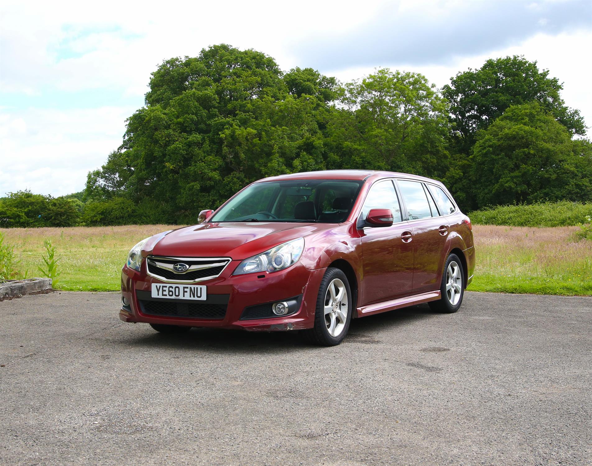 Subaru Legacy SE CVT estate car in red. 2010. Registration number YE60 FNU. First registered