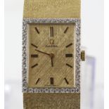 Omega, a ladies gold dress wristwatch the bezel set with diamonds around a signed dial with baton