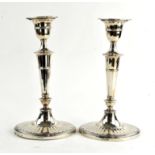 Pair of late Victorian fluted oval tapering silver presentation candlesticks by Hawksworth,