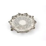 Silver waiter, with shell and scroll border, and chased floral design to the centre (possibly