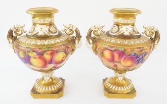 Pair of Royal Worcester twin-handled vases painted with fruit, one by P. Platt, the other S.