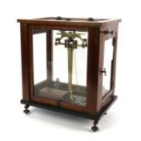 Mahogany cased brass laboratory scales, by Paul Bunge Hamburg, with a box of weights, H43 W37 D26.