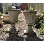 Pair of reconstituted stone garden urns of cylindrical tapering form with square bases, 64 cm high,