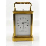 French brass and four glass repeating carriage clock with lever movement, the white enamelled dial