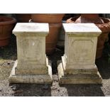 Pair of reconstituted stone square panelled plinths, 47 cm high, 30 cm square