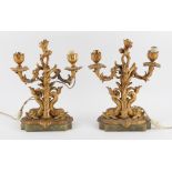 Pair of gilt metal twin branch candelabra on foliate and dolphin columns and onyx bases, 30.