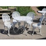 White painted aluminium circular garden table and four chairs, with anthemion design backs,