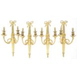 Set of four Louis XVI style gilt metal twin branch wall lights, with ribbon tied and stop fluted