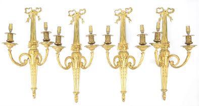 Set of four Louis XVI style gilt metal twin branch wall lights, with ribbon tied and stop fluted
