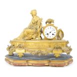French 19th century gilt metal mantel clock, with figure holding wheatsheaves beside an enamel dial