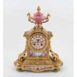 19th century French gilt metal mantel clock, with pink porcelain plaques, the urn finial over a