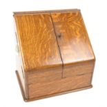 Late Victorian oak stationery box, the sloping twin doors enclosing a perpetual calendar and