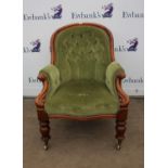 Victorian walnut buttonback armchair, in green upholstery, with curved arms and turned tapering