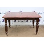 Early 20th century mahogany extending dining table, the rectangular top on reeded legs with pot