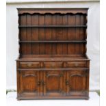 Titchmarsh and Goodwin oak dresser and rack, with three drawers over three panelled doors on block