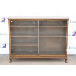 20th century mahogany bookcase with carved decoration, sliding glass doors on squat carved cabriole