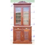 Early 20th century mahogany bookcase cabinet, the shell carved top over glazed doors above a base