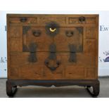 A Korean chest, 19th century with a deep patina, two drawers and a compartment, and iron hardware.