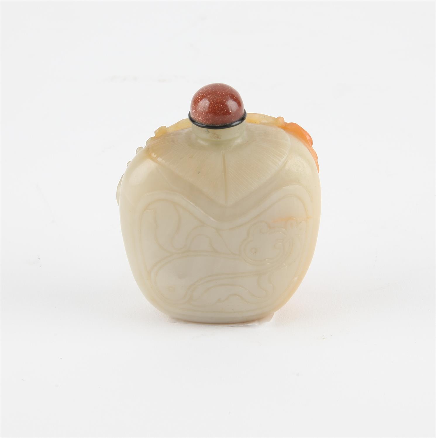 A Chinese pale greenish and russet jade snuff bottle. Finely carved with pine Tree, deer and a bat. - Image 2 of 2