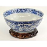 A large Chinese blue and white Bowl, Qing dynasty painted on the inside with a bird on a floral