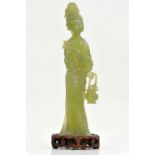 A Jade Sculpture of a Lady , Republic period. The standing lady holding in one hand a basket with