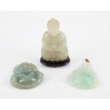 A collection of Chinese jades. To include a pale celadon jade carving of a seated buddha on lotus