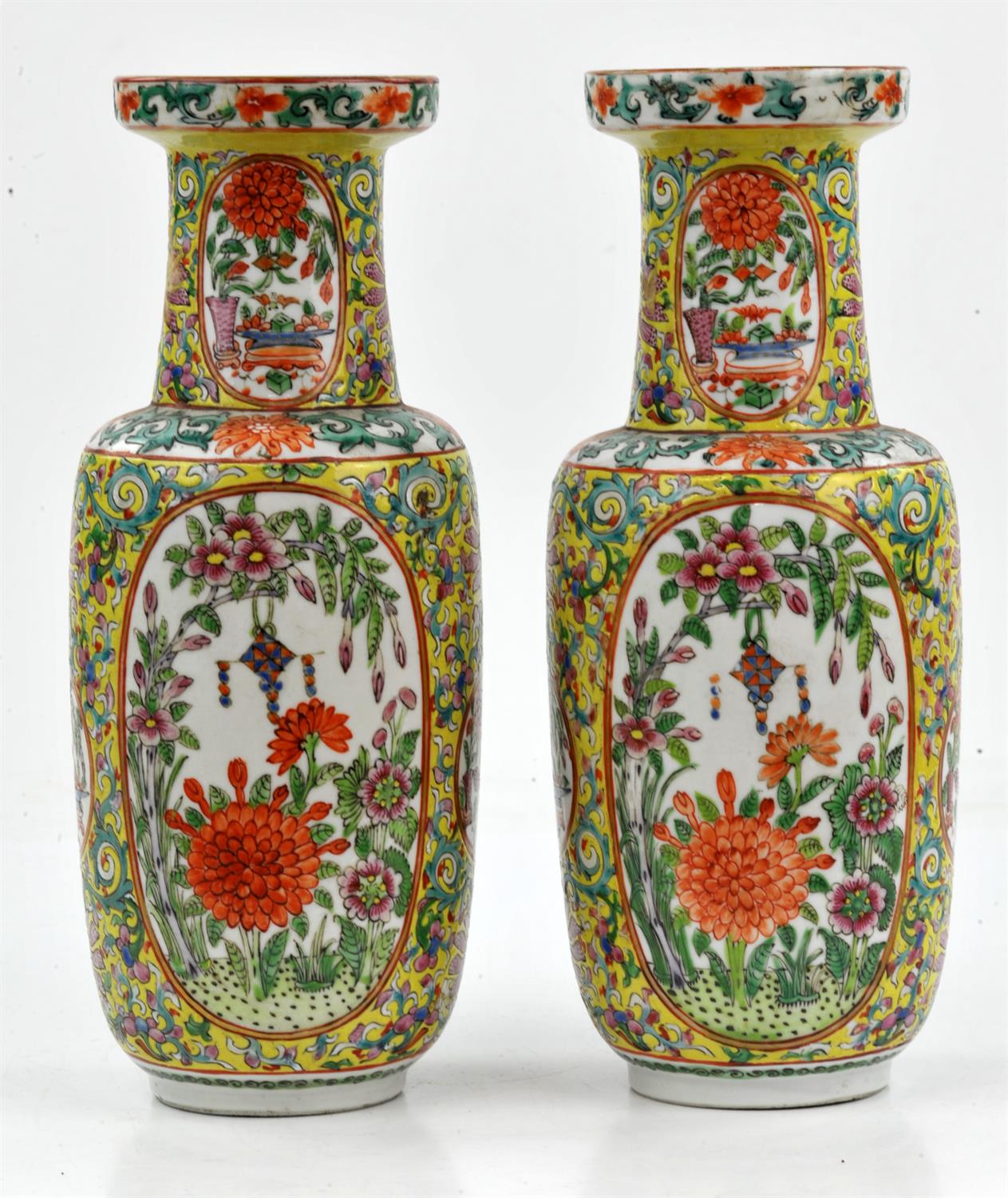 A pair of Chinese yellow ground Famille Rose vases, 19/20th century. Painted with panels with