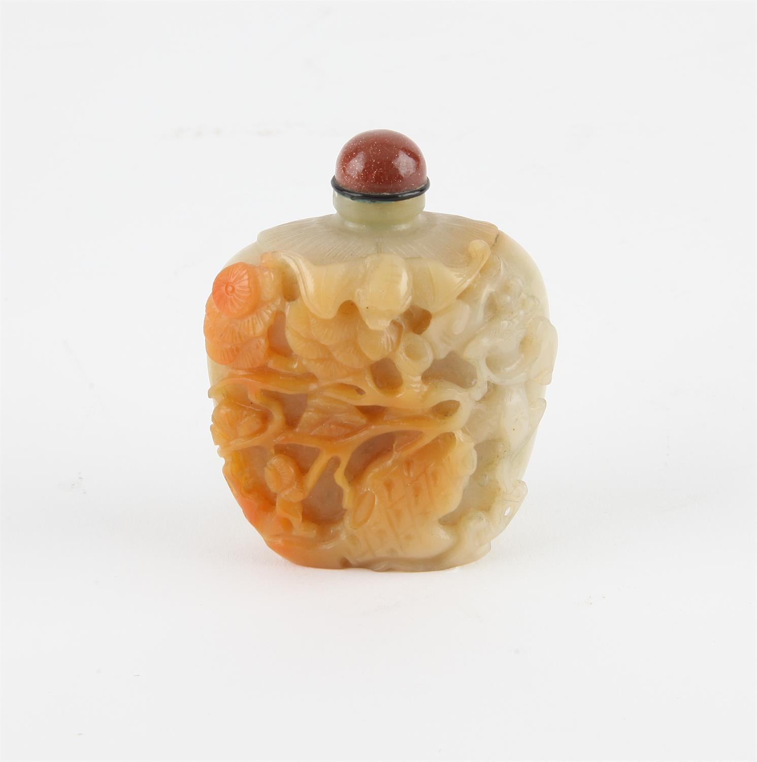 A Chinese pale greenish and russet jade snuff bottle. Finely carved with pine Tree, deer and a bat.
