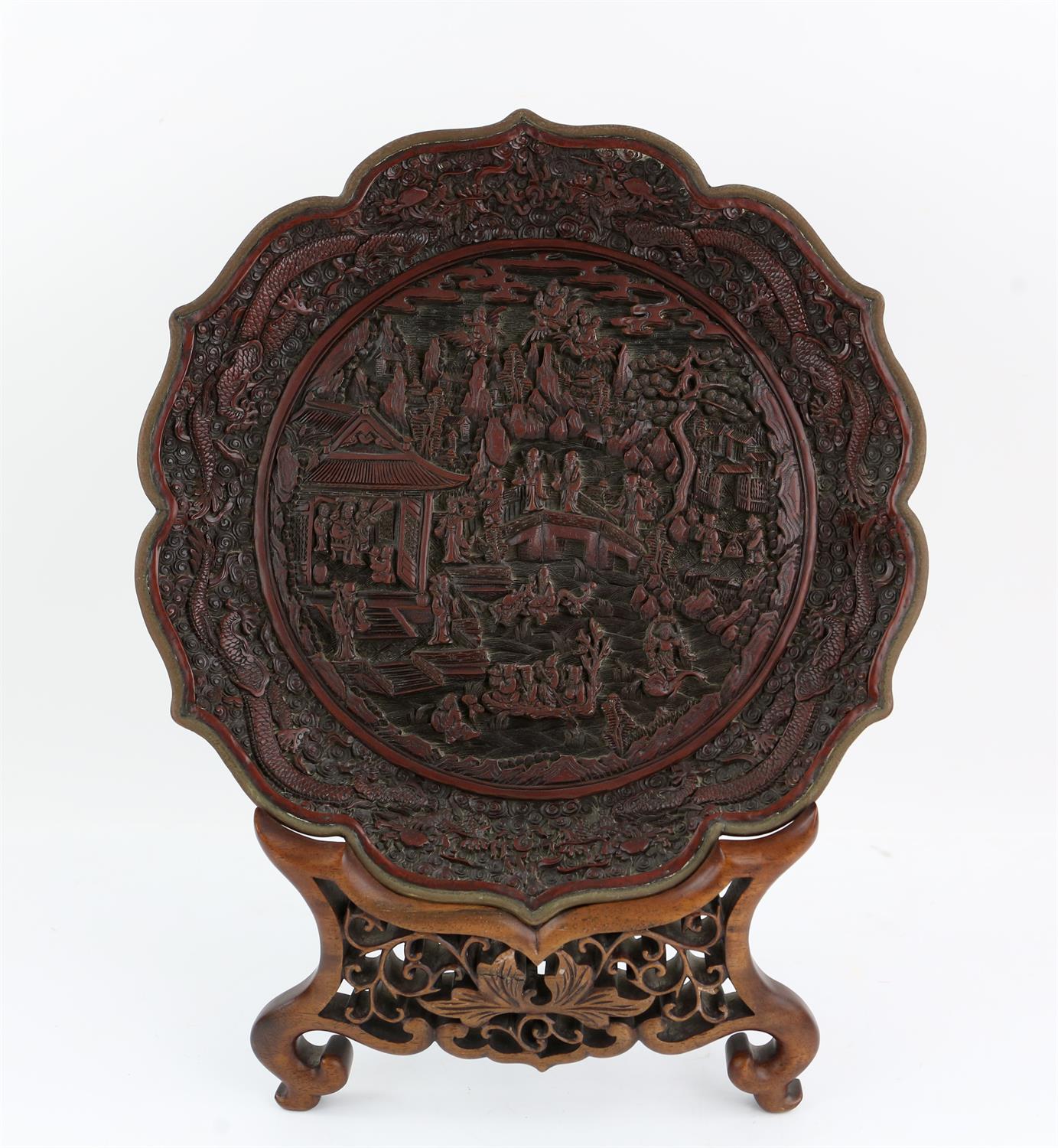 A Chinese Cinnabar Lacquer Dish , Qing dynasty. Its petalate rim finished with a metal band above