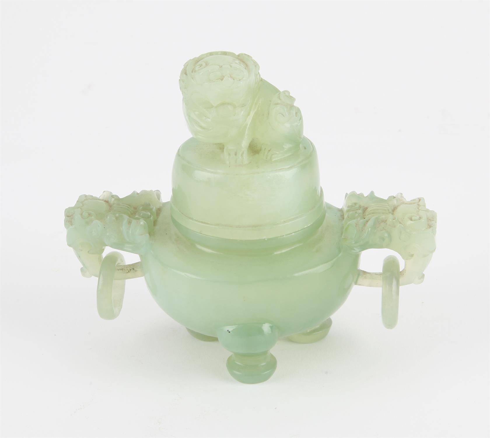 A Chinese Xiu Jade Tripod censer. Decorated with Foo dog finial and Foo dog head handles to sides
