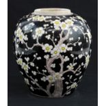 A Chinese Famille Noire Jar, Qing dynasty painted with flowering prunus design, the flowers