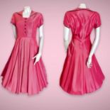 Original mid 1950s dark coral pink viscose tea dress in "New Look" style. Short sleeves with black