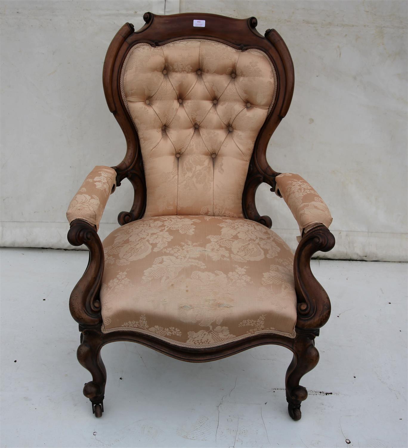 Victorian mahogany fireside arm chair, the button back and padded arms on cabriole legs and pot