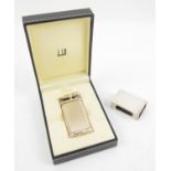 Silver matchbox holder and a cased Dunhill lighter with paperwork