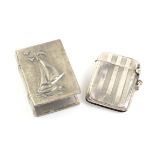 Engine turned silver vesta case, Birmingham, 1920 and a white metal yacht or boat design matchbox