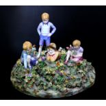 Crown Staffordshire Porcelain Figure of Children in a Garden, modelled by T Bayley