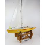 Radio controlled model pond yacht, 'Dave The Boat', single mast, two sails, yellow hull, 78cm long,