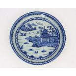 18th century English stoneware dish, decorated in under glazed blue with a pagoda pattern 33cm dia.