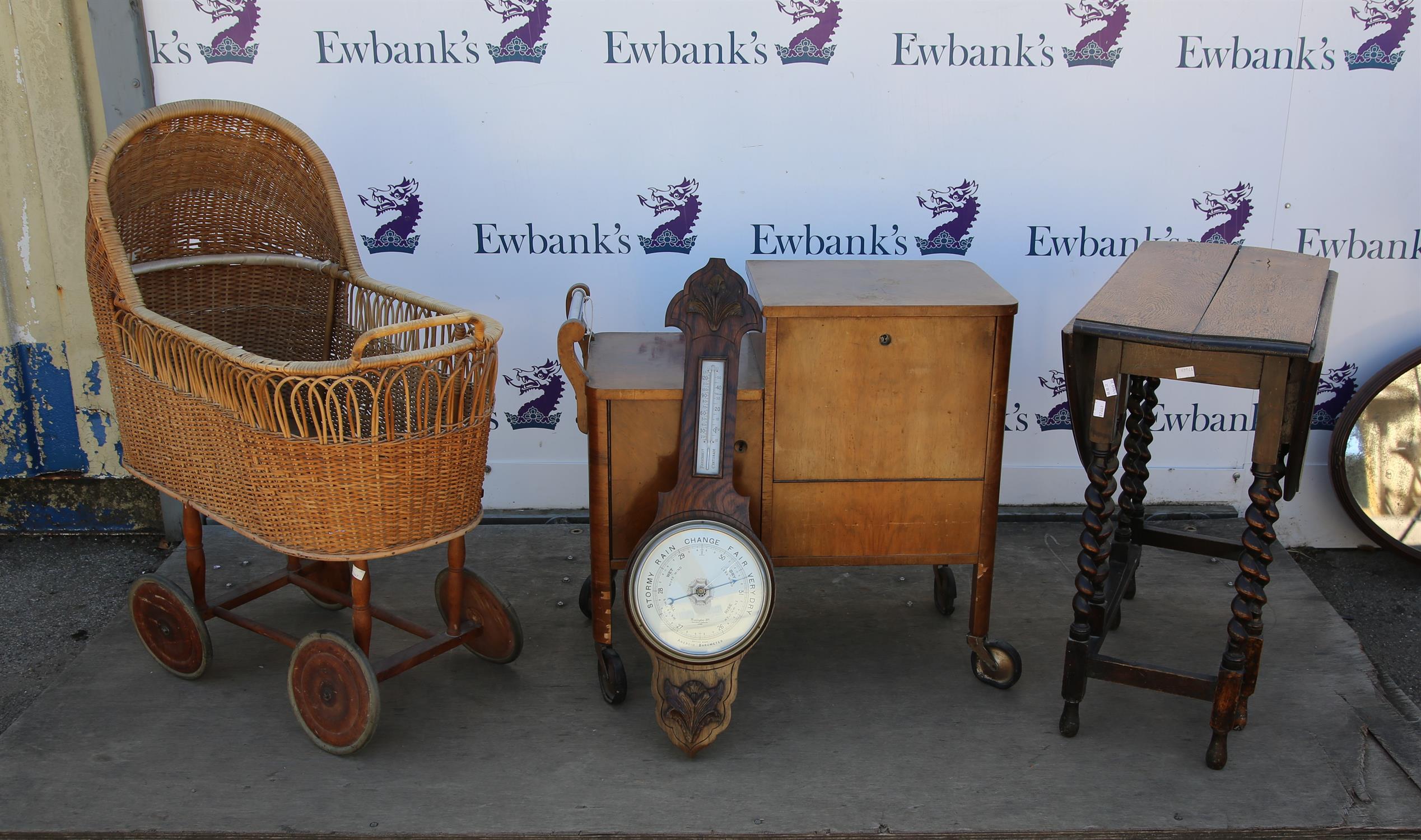 Victorian canework pram, a walnut drinks trolley, an oak gateleg table and a carved oak barometer