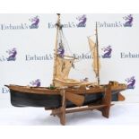 Scratch built wooden model of a two masted sailing vessel, (unfinished), 126cm long, on stand,