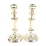 Pair of silver candlesticks with embossed decoration by **** and Co, Birmingham, c1963, height 9"