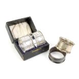 Two silver napkin rings and a cased pair of white metal napkin rings