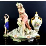 Royal Dux figure of a young girl seated by a spring, H33cm, continental figure of a semi naked girl,