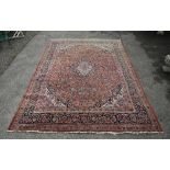 Persian rug red ground with all over foliate design with central lozenge within multiple borders,