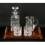 Cut glass decanter, jug and two glasses on twin-handled burr walnut tray,