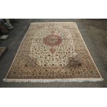 Persian carpet, the red medallion on an ivory field with allo.......ver floral design within a