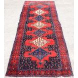 Persian Naravan Runner, heavy pile, with six medallions on a red ground, 348 x 123cm
